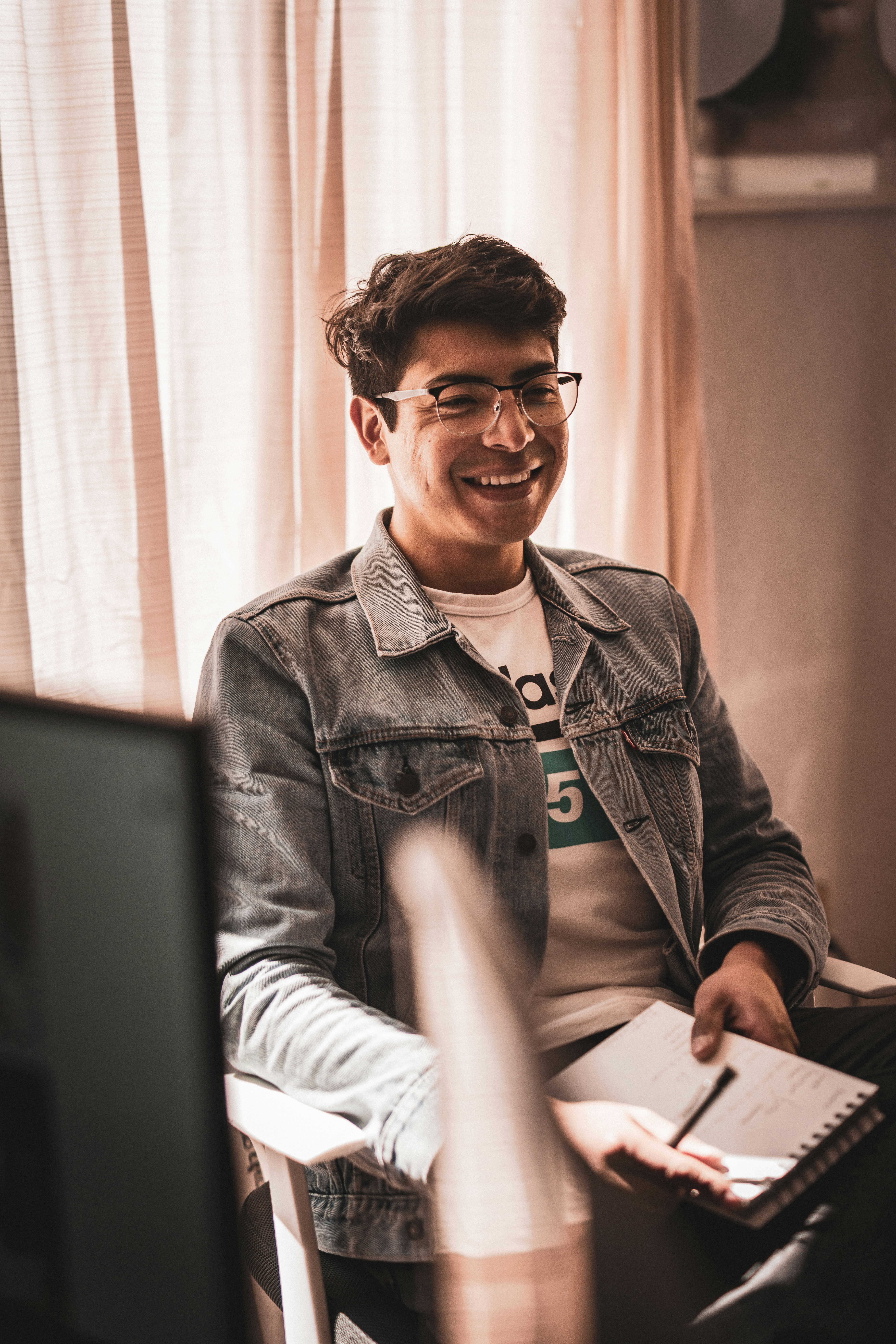 man in white crew neck shirt wearing black framed eyeglasses