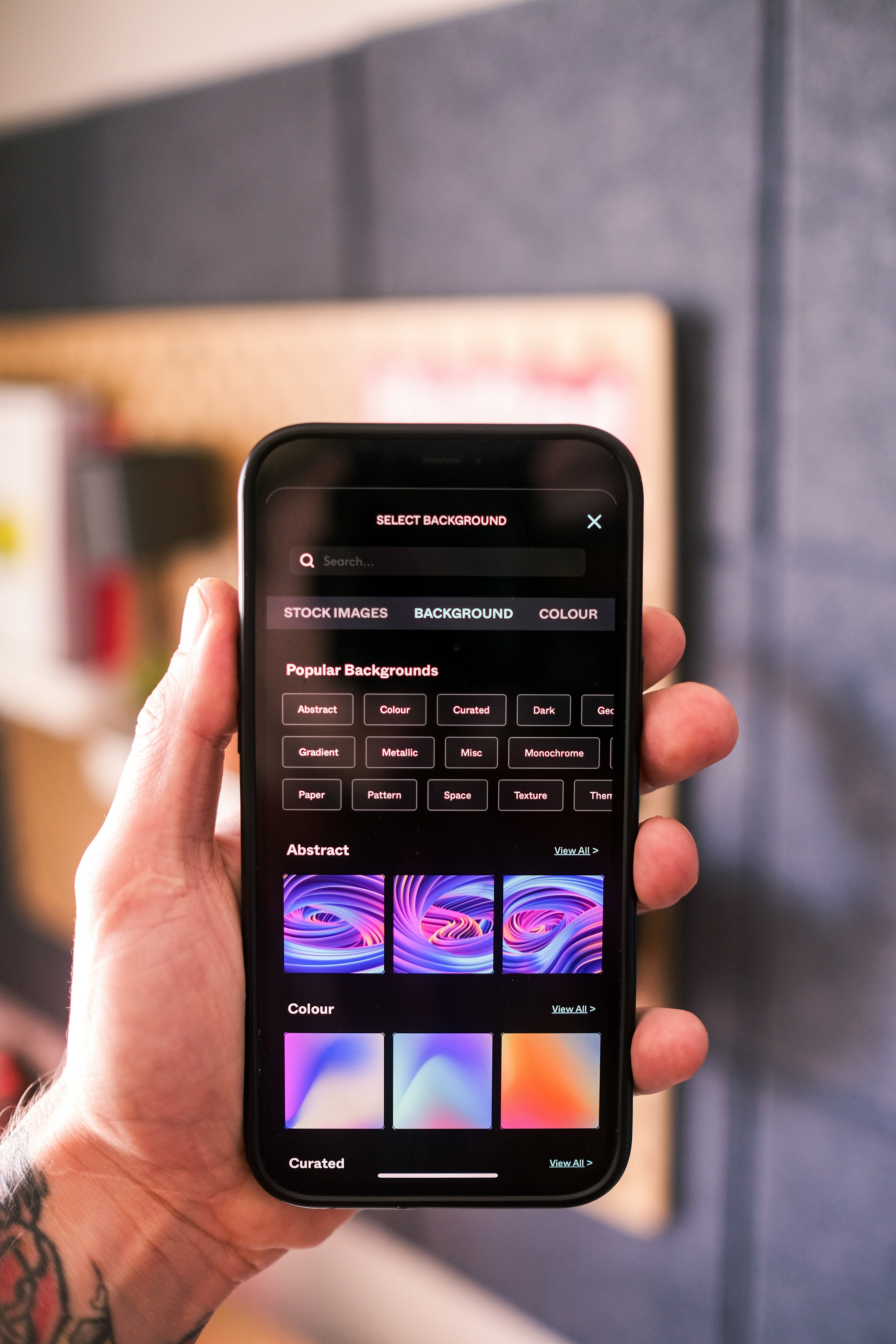 silver iPhone X floating over open palm