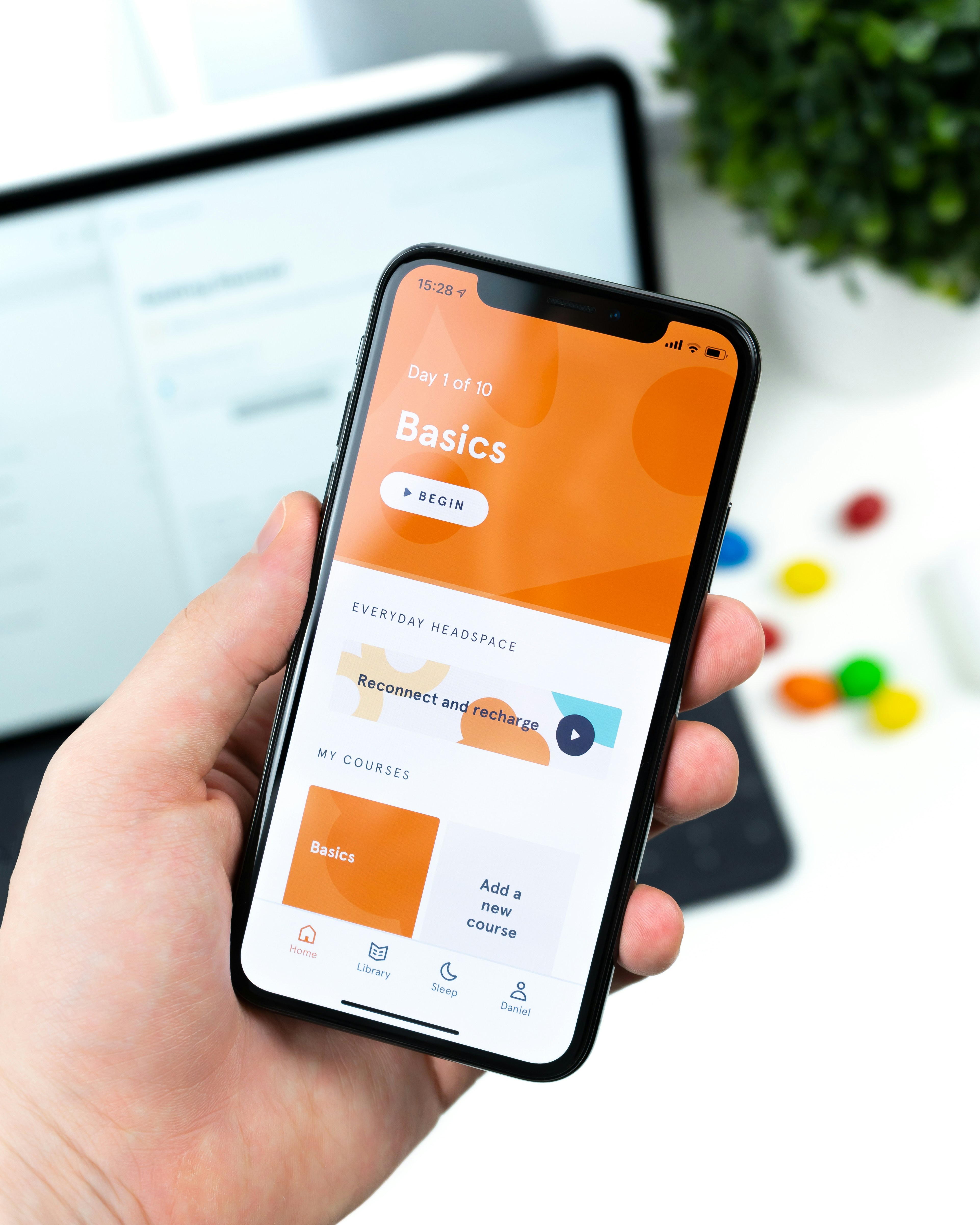 silver iPhone X floating over open palm